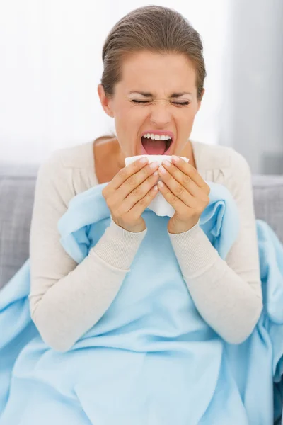 Young woman sneezing