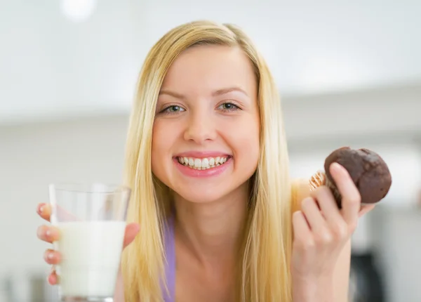 Woman with milk and chocolate muffin