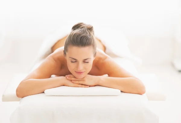 Relaxed woman laying on massage table