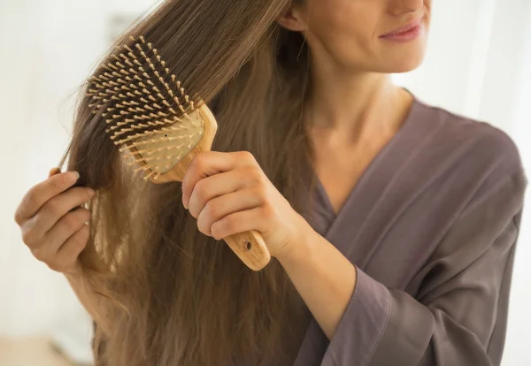 Woman combing hair