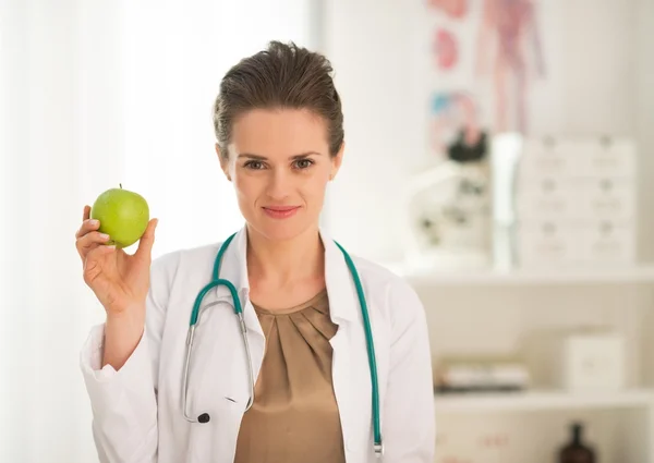 Medical doctor woman showing apple