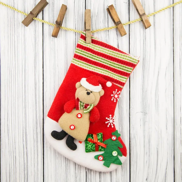 Christmas gifts for his boots isolated on wood background