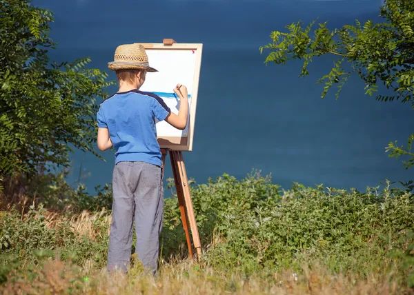 Young artist starting his work, outdoor