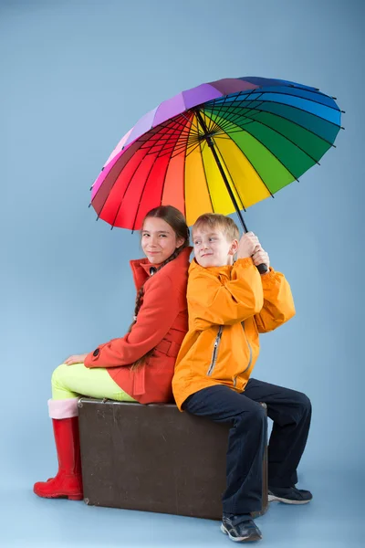 Children with a colorful umbrella