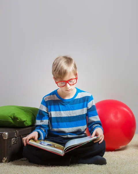 Preteen boy reading a book