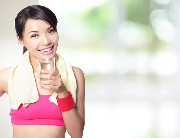 Sport girl drinking water after sport