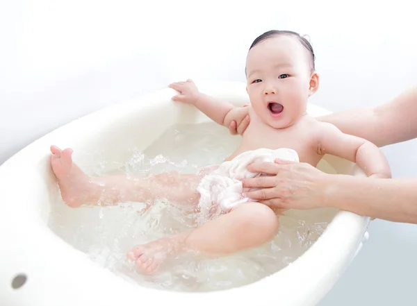 Funny face of baby taking bath