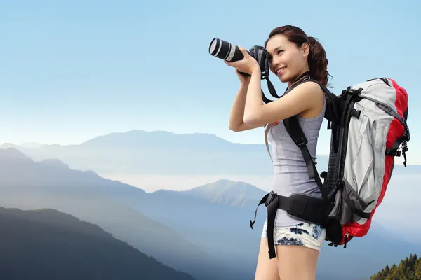 Woman mountain hiker taking pictures