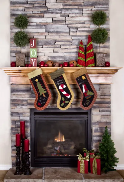 Christmas stockings hanging from a mantel or fireplace
