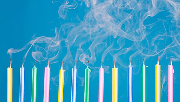 Birthday candles in a row with smoke