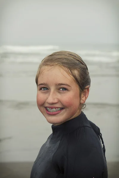 Girl wearing wet suit on Rockaway beach Oregon