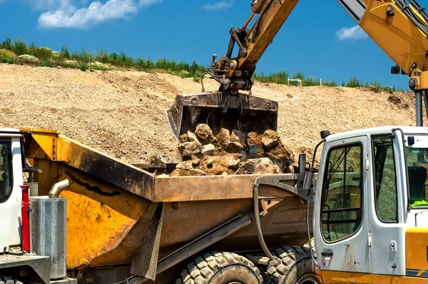 Heavy duty construction vehicles, moving stones