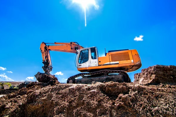 Industrial heavy duty excavator moving earth