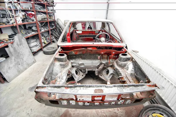 General view of vintage car in restoration process at car workshop