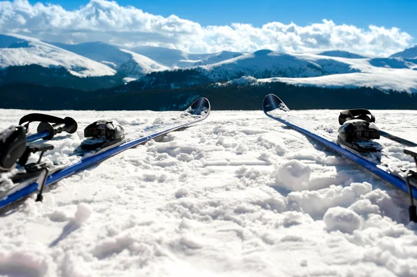 Skis and equipment on mountain slope in winter season