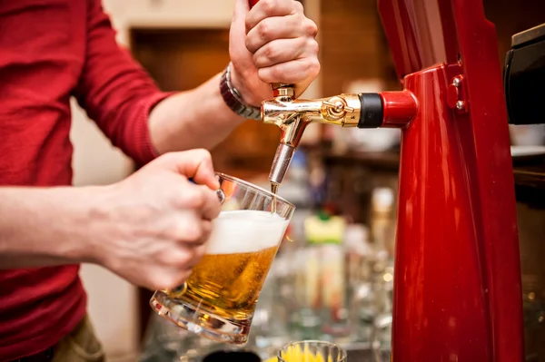 Barman brewing a draft, unfiltered beer at pub or bar