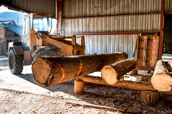 Industrial log loader operating at industrial wood production factory