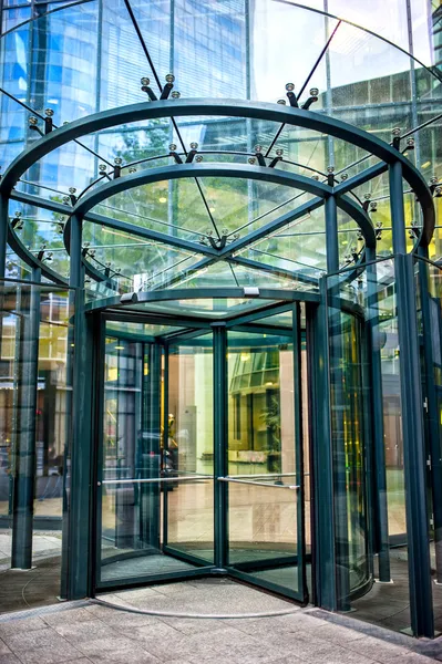 Close-up of modern secured glass door at corporate business building. Revolving door at business center or corporate building