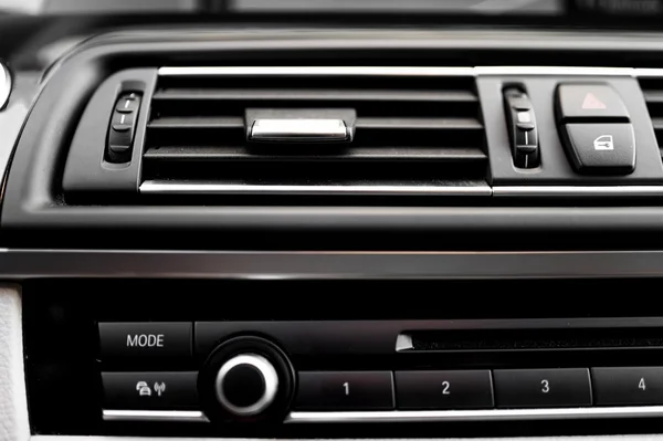 Modern car interior with close-up of ventilation system holes and air conditioning. Concept wallpaper for auto air conditioning and climage control