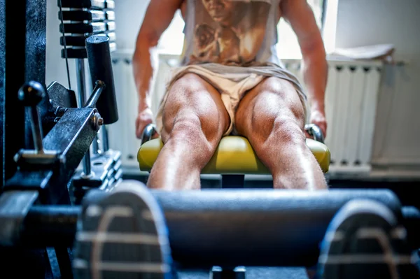 Close-up of muscular feet of a bodybuilder in the gym