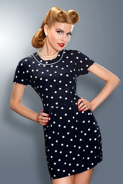 Pin-up girl in retro vintage old-fashioned dress posing