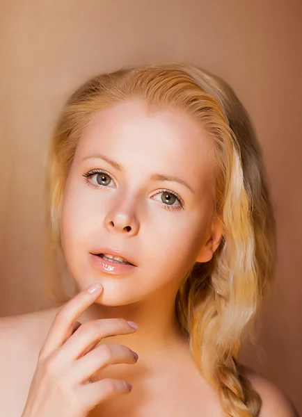 Portrait of Pretty Young Woman Blonde touching her Fresh Face
