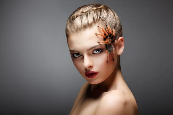 Portrait of Spider-Girl Fashion Model with Poisonous Spider on her Face