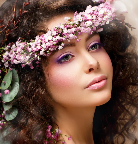 Closeup Portrait of Pretty Woman with Wreath of Pink Flowers. Natural Beauty