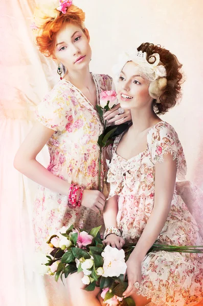 Freshness. Two Young Pretty Women in Classic Vintage Dresses with Flowers. Pin-up Style