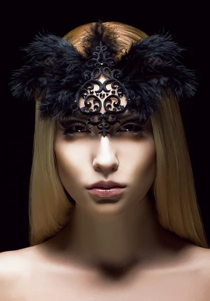 Beautiful Genuine Woman in Styled Black Mask with Feathers. Aristocratic Face