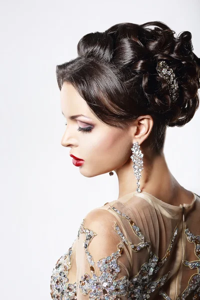 Profile of Classy Brown Hair Lady with Jewelry and Festive Hairstyle