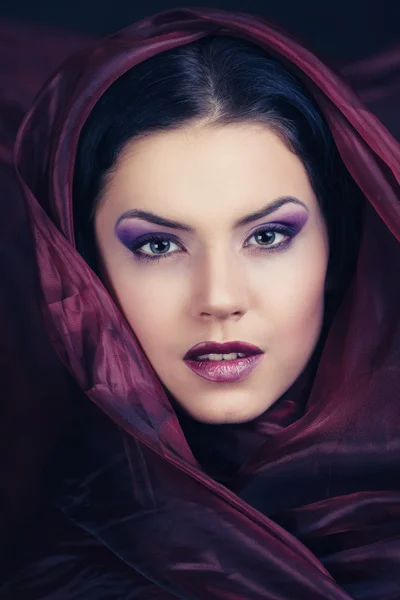 Gorgeous woman with purple color scarf