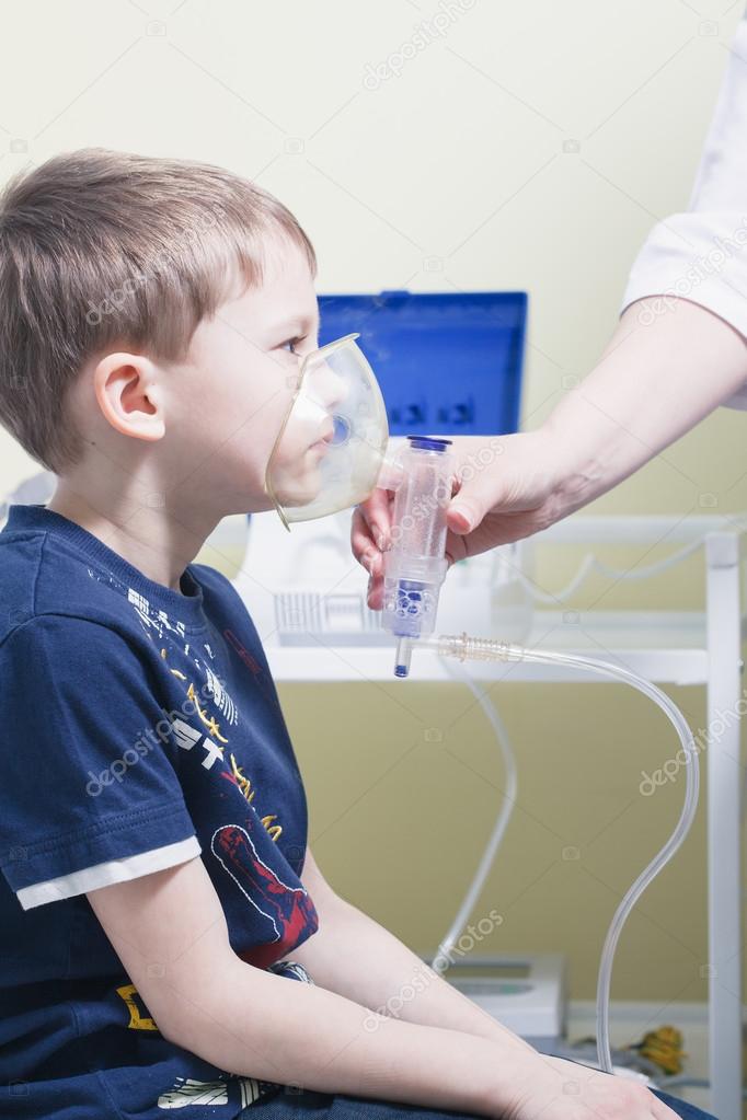 Close up image of a little boy with asthma using oxygen mask. Wh