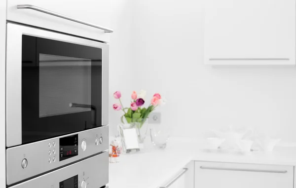 Modern white kitchen with stylish furniture