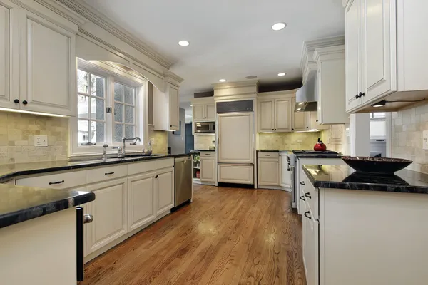 Kitchen with black granite counters