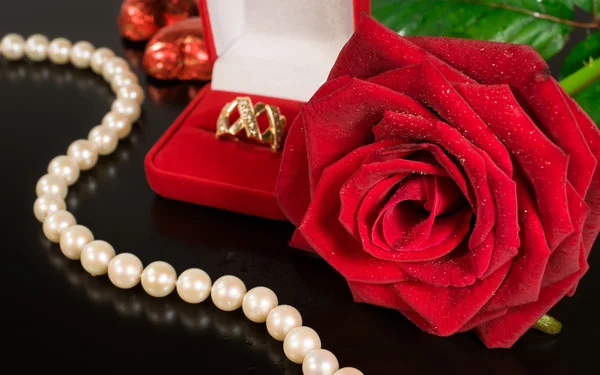 Wedding background .Rose , pearls and a gold ring