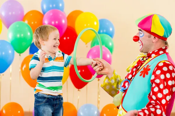 Clown amusing kid boy on birthday party