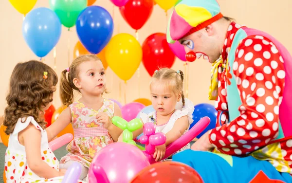 Children girls and clown on birthday party