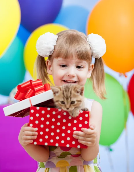 Kid girl with colorful balloons and kitten in gifting box