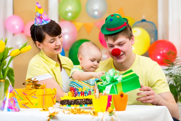 Family celebrating first birthday of baby
