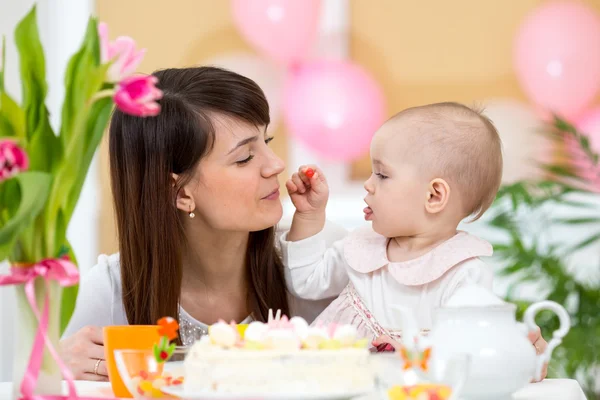 Baby and mother celebrate first birthday holiday
