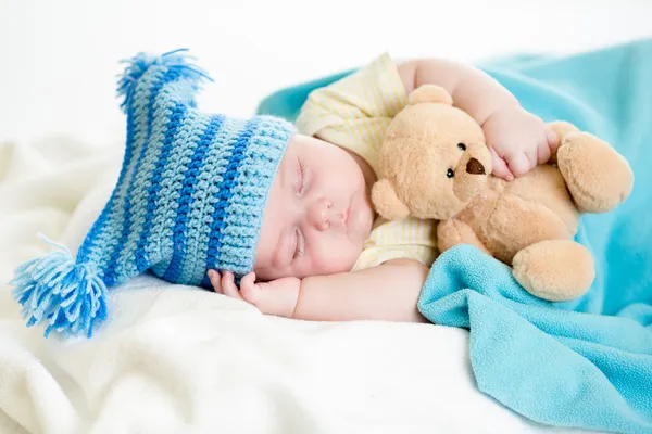 Sleeping baby boy with toy