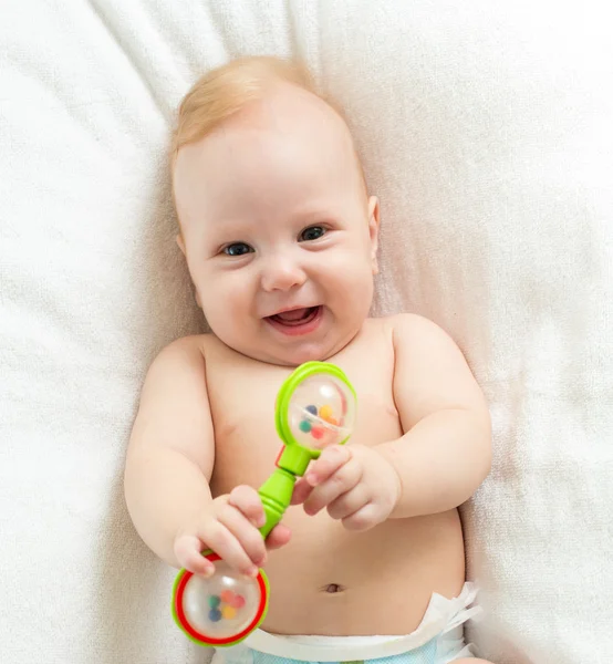Smiling baby boy with toy