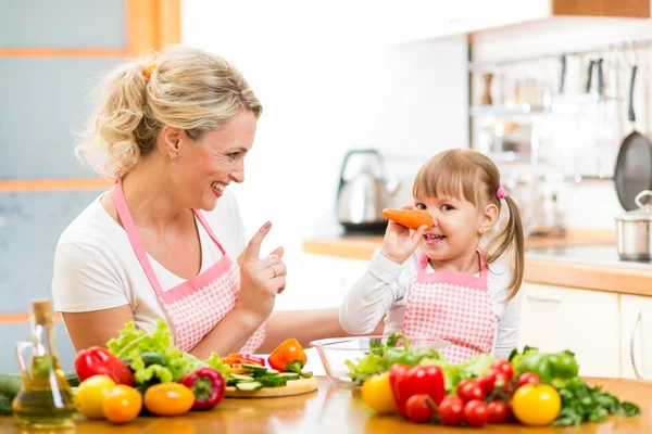 Mother and her child preparing healthy food and having fun