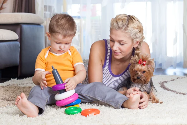 Cute mother and kid boy play together indoor