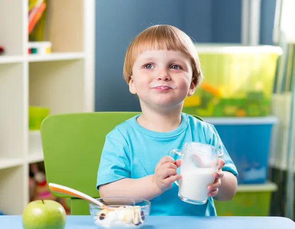 Kid boy drinking milk