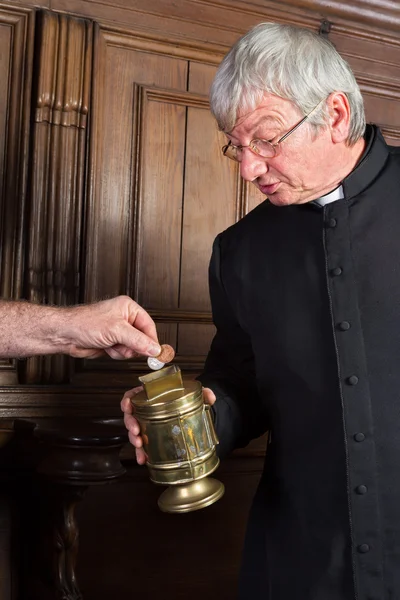 Priest collecting money