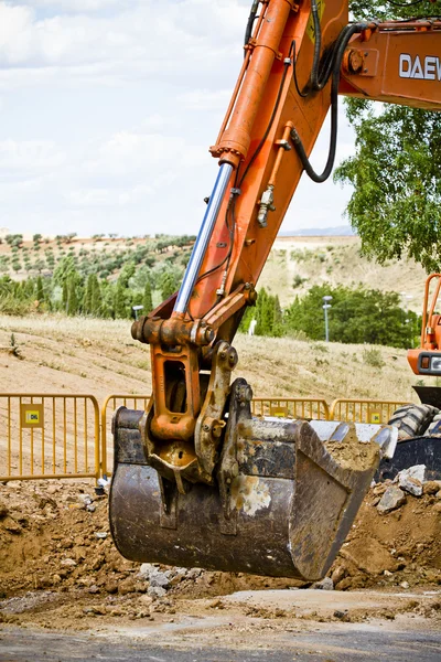 Excavator loader machine during earthmoving works outdoors at co