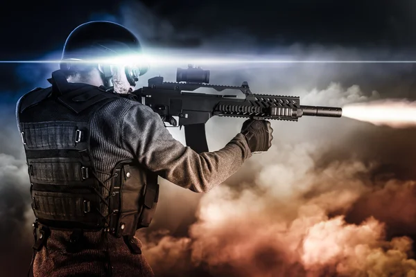 Assault soldier with rifle on apocalyptic clouds, firing