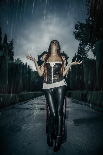 Under the storm, Beautiful vampire woman in palace gate, gothic